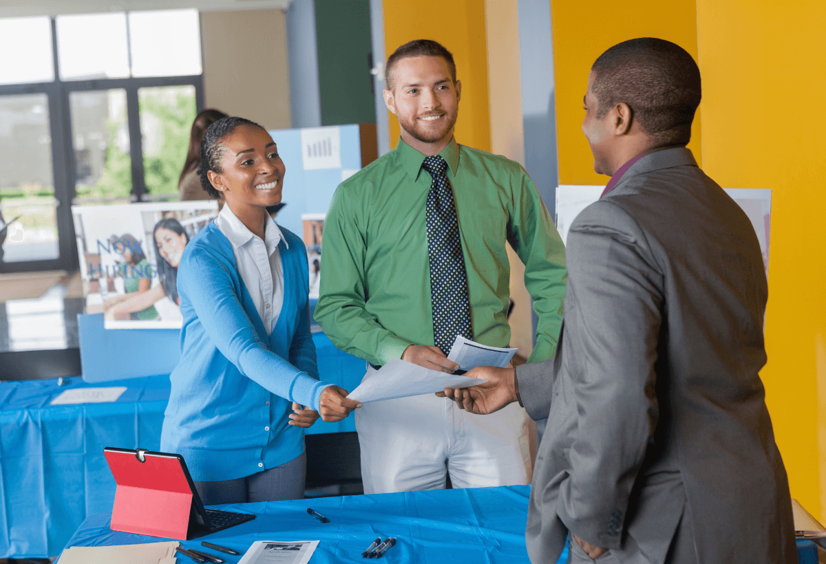 Young couple signing a contract on a meeting with investment agent in the office.