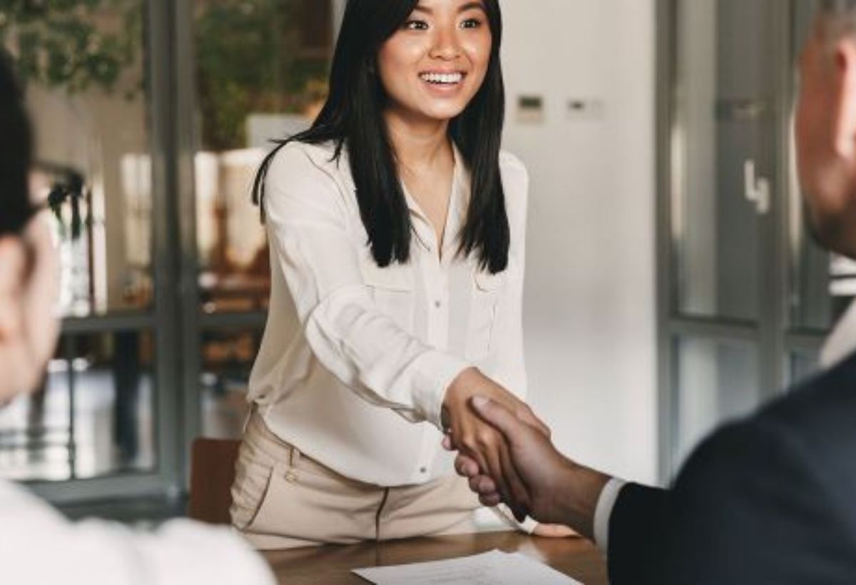 Young couple signing a contract on a meeting with investment agent in the office.